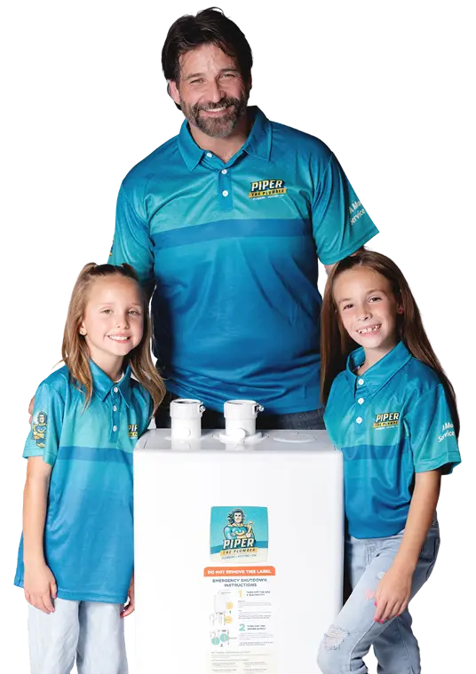 Piper the Plumber team with a tankless water heater unit in Red Deer